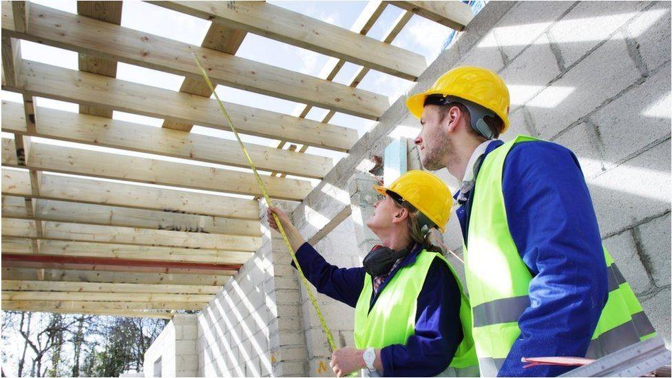 Man and woman inside a partly-built house