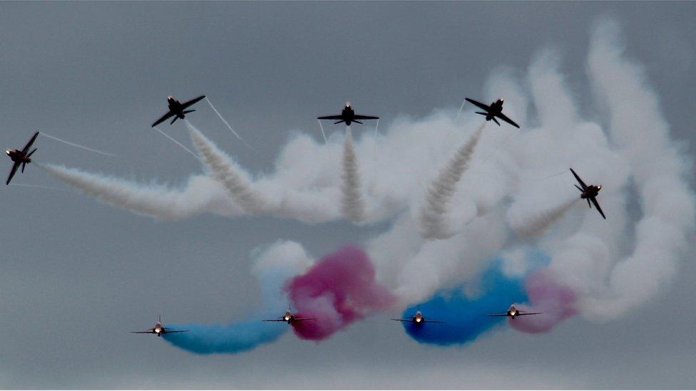 A dramatic shot of the Red Arrows