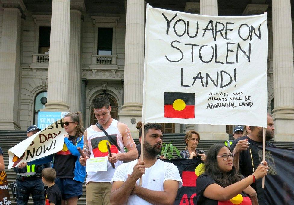 Aboriginal protesters hold signs as they demonstrate outside the Victorian State Parliament on Australia Day in Melbourne, Australia, 26 January 2017.