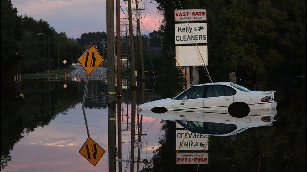 Car abandoned in deep floodwaters