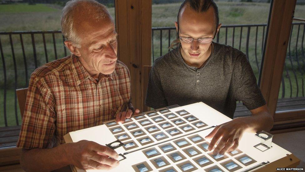 Colin and Kieran Baxter looking at their slides of the glacier (Image: