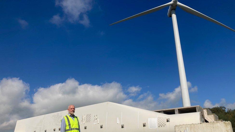 Kenny McDonald by a wind turbine