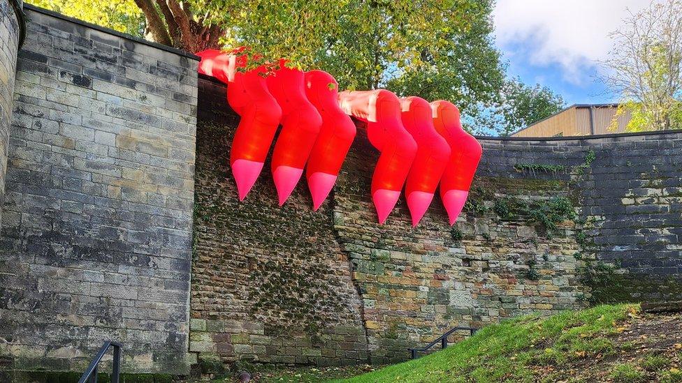 Inflatable monster hands on a wall at Nottingham Castle