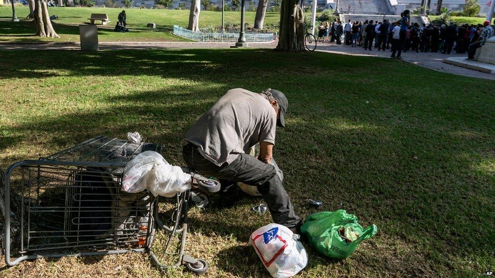 A person sorts recyclables on the south lawn of City Hall in Los Angeles on 22 September 2015