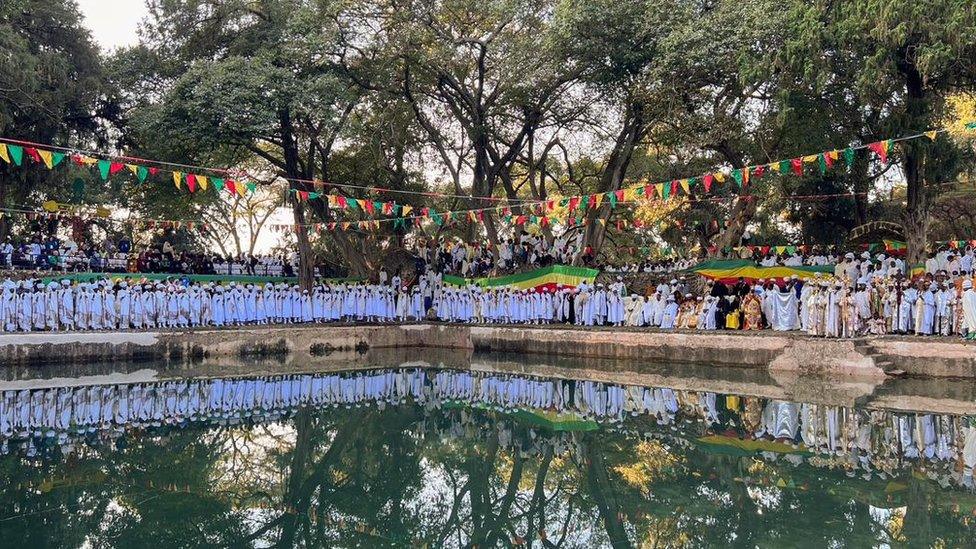 Attendees line the baptism pool