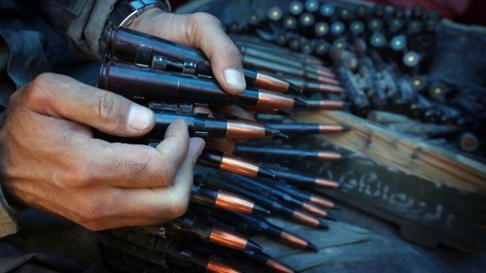 An Iraqi Kurdish holds a gun