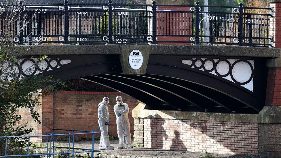 Forensic officers under bridge