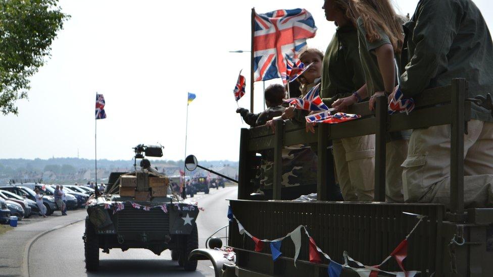 people on back of vintage car in Guernsey