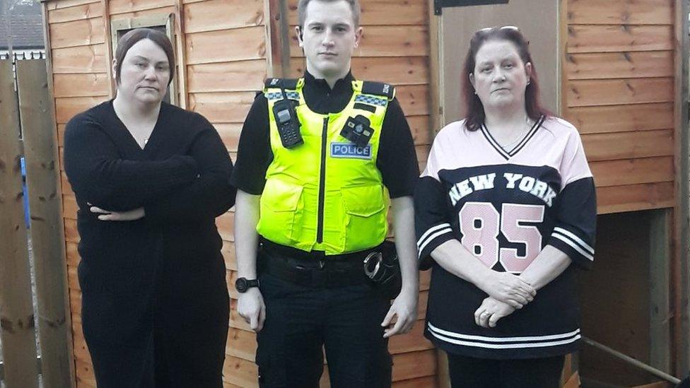 Officer with centre volunteers and damaged shed