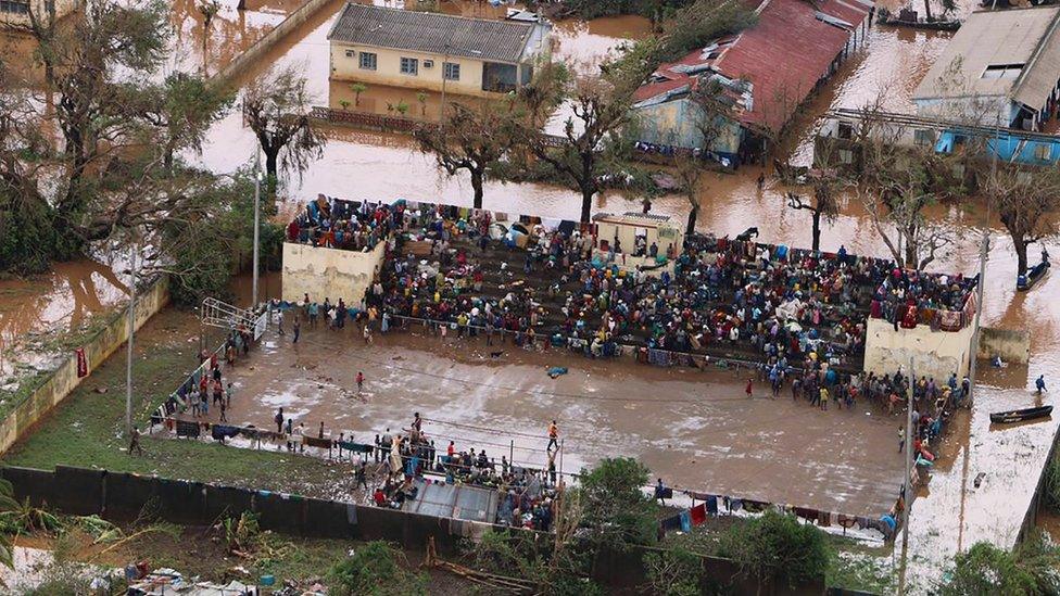 People in the flooded Mozambique town of Buzi stranded on a football stand.