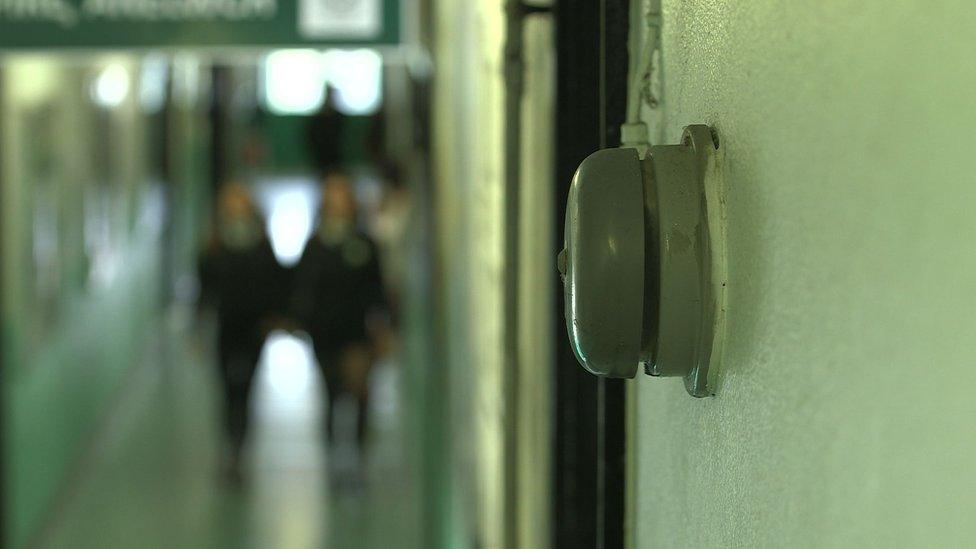 Blurred teenagers in school corridor