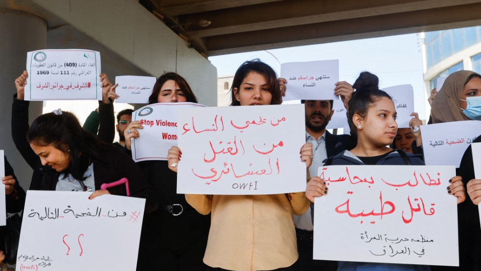 Women holding placards