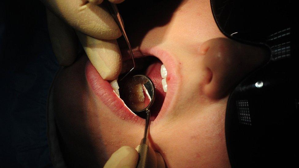 Child being examined by a dentist