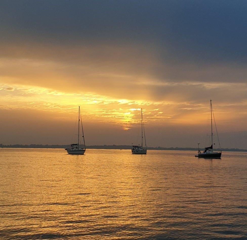 Sunset over boats on water