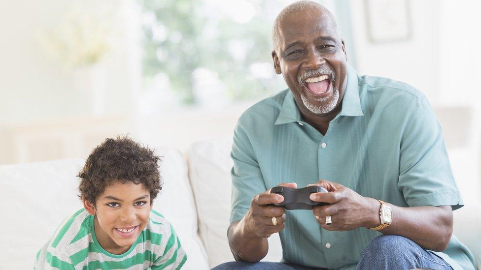 grandfather-playing-games-with-grandson-smiling