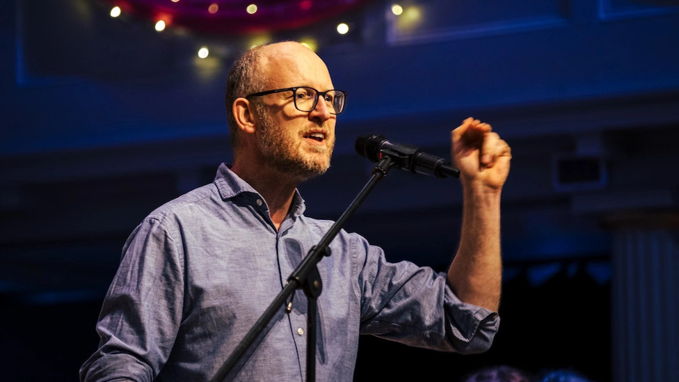 Jonathan James speaking into microphone