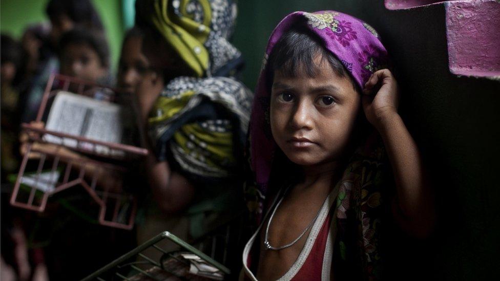 SHAMLAPUR, BANGLADESH - JULY 4: A Rohingya child holds a Koran during class at a madrassa in an informal settlement July 4, 2015 in Shamlapur, Bangladesh.