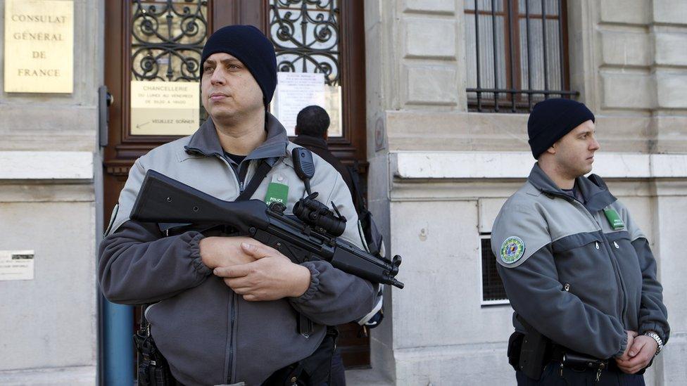 Security officers control area in front of French consulate in Geneva, Switzerland, Friday, Dec. 11, 2015