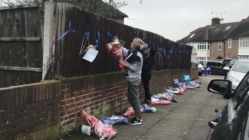 Friends and family of Henry Vincent tie tributes to a fence