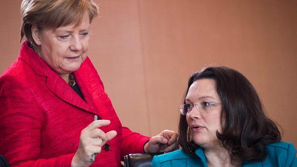 File image of German Chancellor Angela Merkel (L) speaking to Andrea Nahles on 29 March 2017