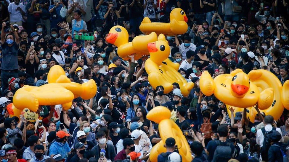 Pro-democracy demonstrators move inflatable rubber ducks during a rally in Bangkok