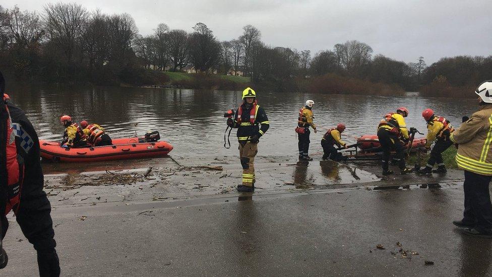 Search teams on the river bank