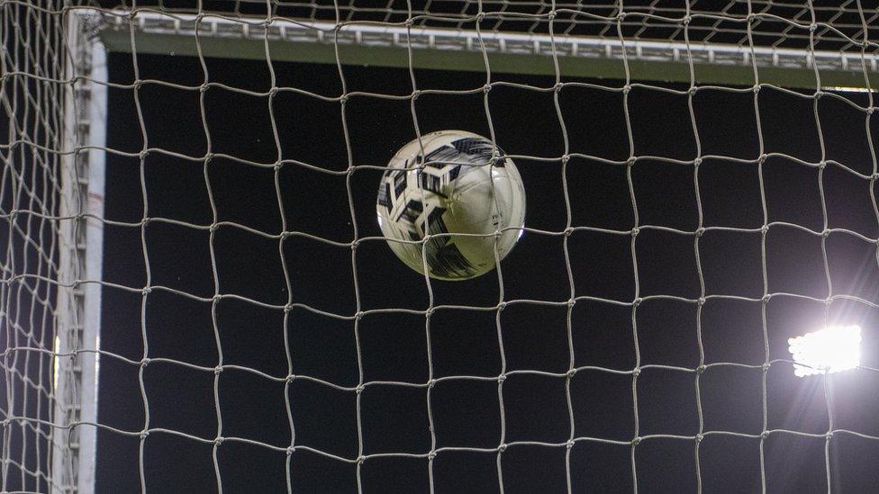 A football goes into a net