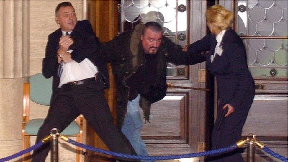 Michael Stone being restrained during the attack at Stormont in 2006