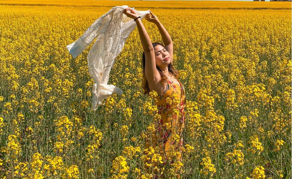 Ridzkhi Andhini poses for a picture among the canola