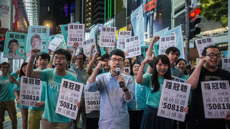 Nathan Law (C) speaks at a rally with Joshua Wong (centre L) and supporters in Causeway bay following Nathan Law's win in the Legislative Council election in Hong Kong on September 5, 2016