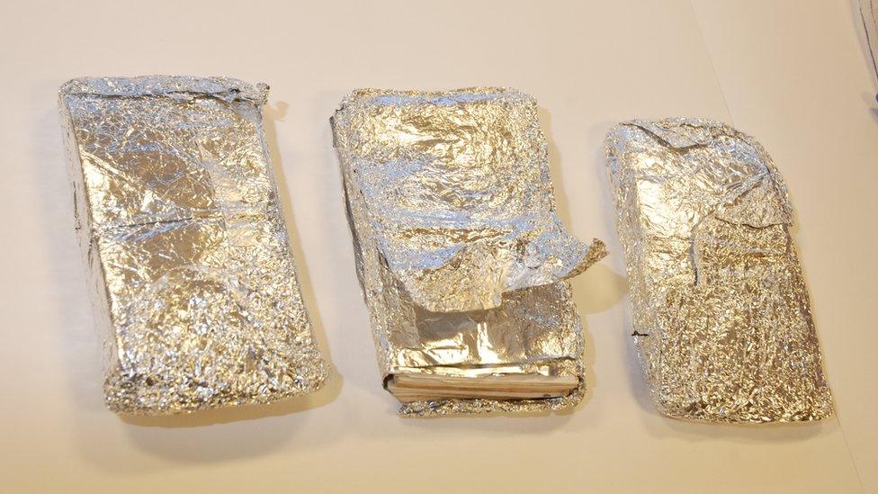 Three foil-wrapped bundles of cash