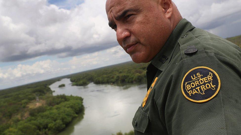 US Border Patrol agent Jose Perales looks into Mexico from the US-Mexico border at the Rio Grande on near Roma, Texas. Republican Presidential candidate Donald Trump has promised to build a wall, at Mexico's expense.