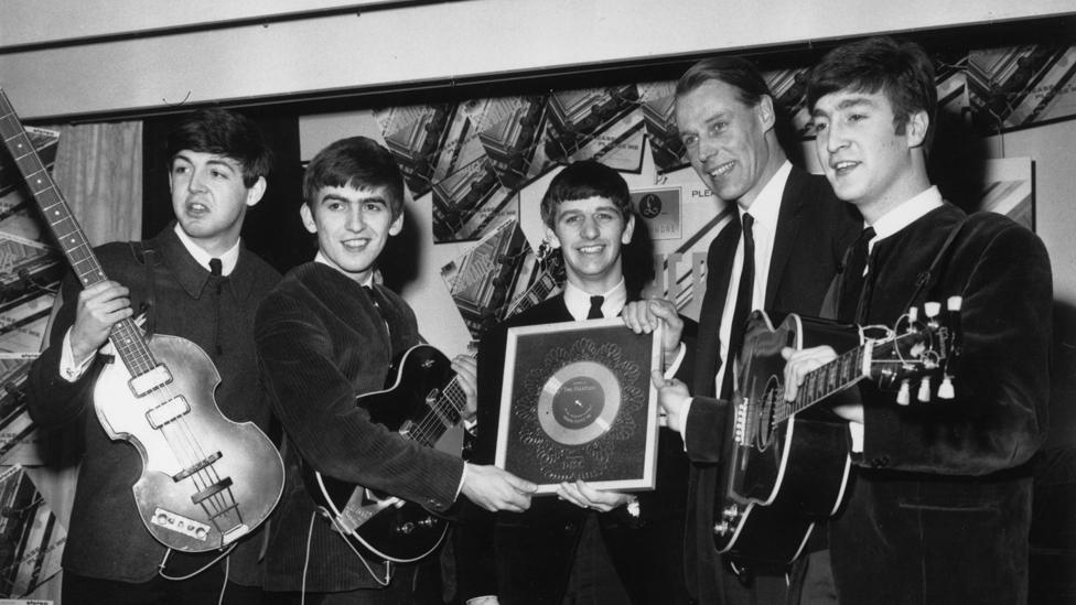 George Martin with the Beatles receiving their first silver disc