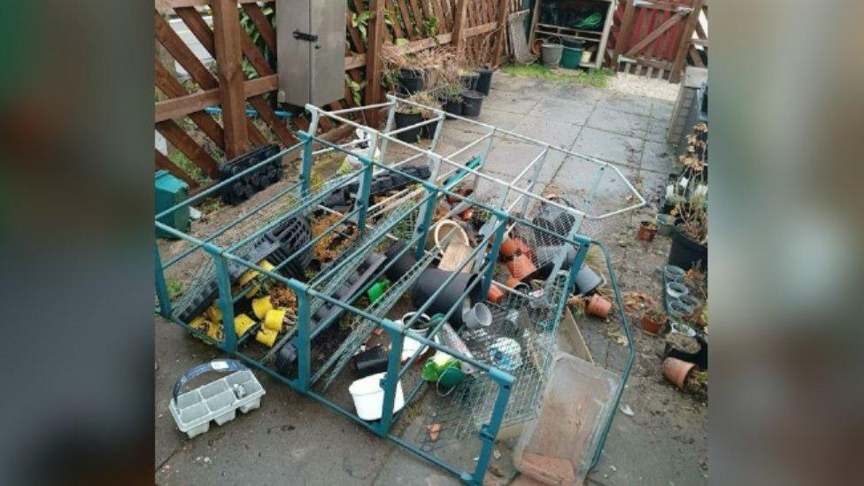 Toppled garden shelf