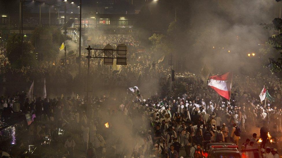 Demonstrators march in Jakarta, Indonesia, after a day of protest, 4 November 2016