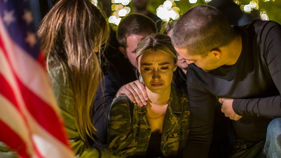 A woman cries during a vigil to pay tribute to the victims of a shooting in Thousand Oaks, California