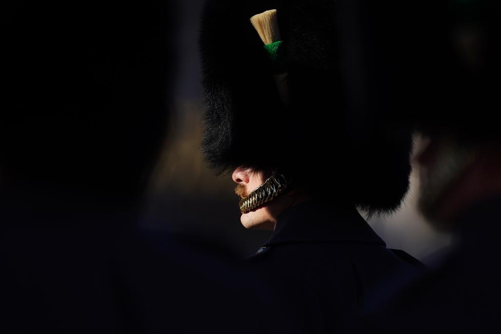 Members of the King's Guard line up outside Buckingham Palace as King Charles III and Queen Camilla depart in the Diamond Jubilee State Coach for the Houses of Parliament ahead of the State Opening of Parliament on November 7, 2023 in London, England.