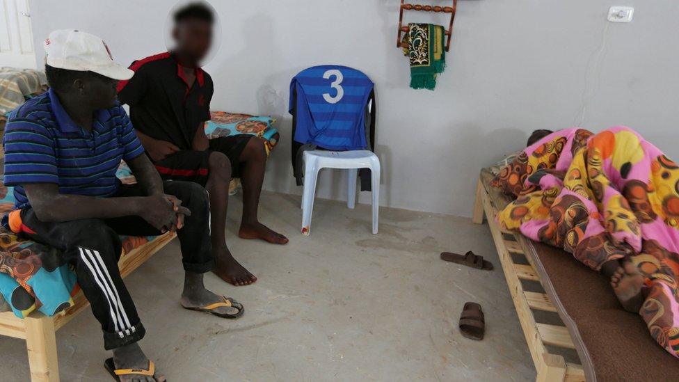 Two survivors sitting on a bed and one under a cover