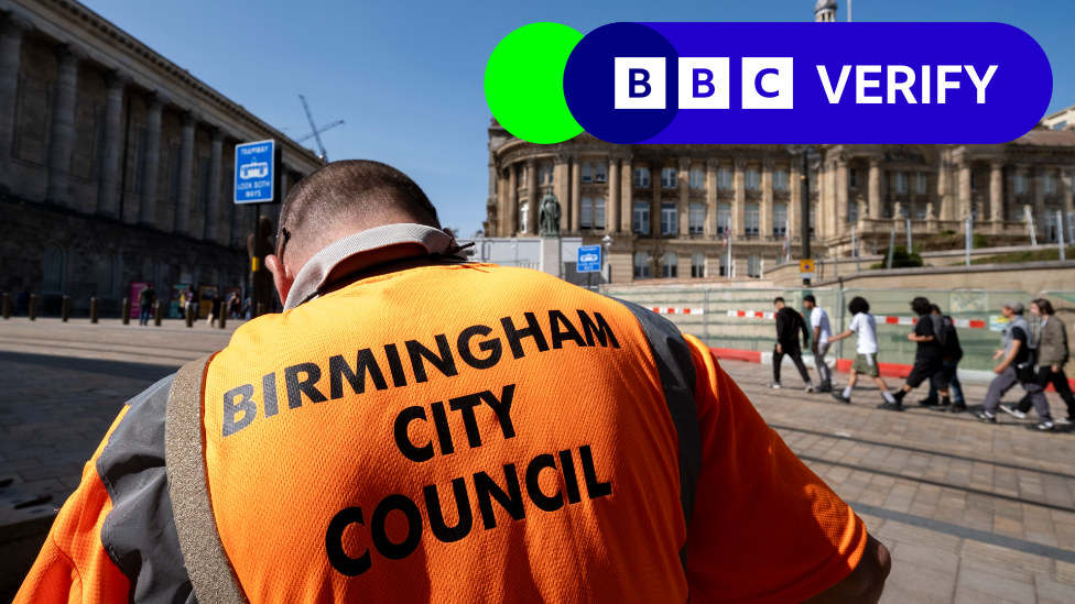 A Birmingham City Council worker collecting refuse outside the town hall