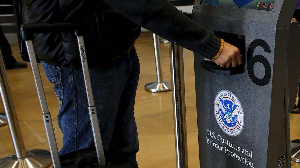 A traveller has his passport scanned as he passes through U.S. Customs and Immigration after using the Cross Border Xpress pedestrian bridge between San Diego and the Tijuana airport on the facility's opening day in Otay Mesa, California December 9, 2015.