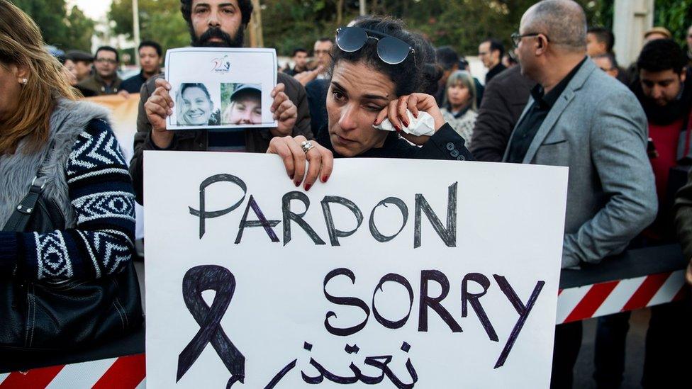 Moroccans attend a vigil for the murdered tourists