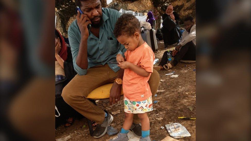 Mohammed with his son Yousif at the evacuation airport