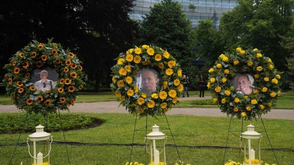 Photographs of victims David Wails, James Furlong and Joe Ritchie Bennett displayed at a memorial service at Forbury Gardens bandstand