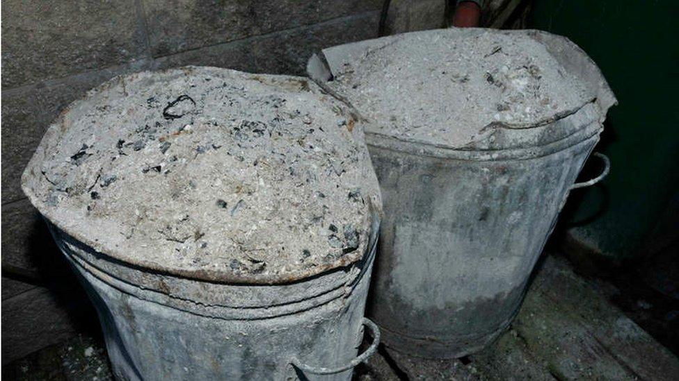 The overflowing ash bins outside the hotel