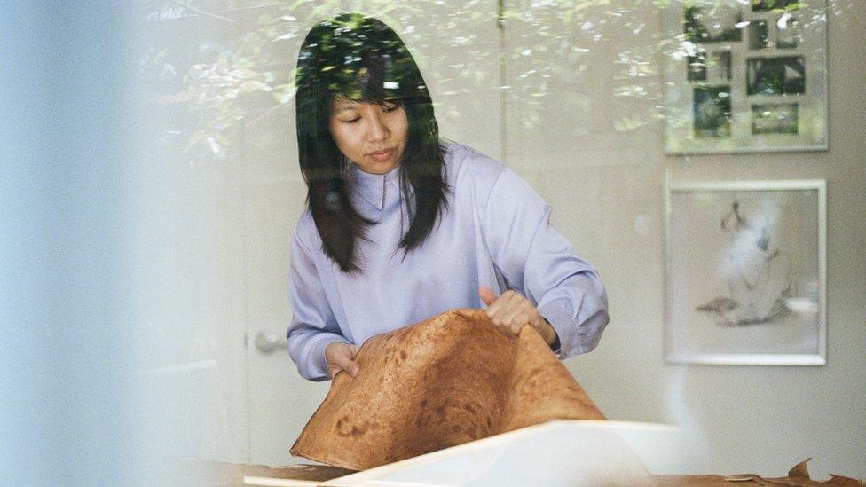 Sophia Wang holding a strip of Reishi