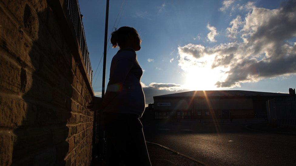 A sex worker standing on a street