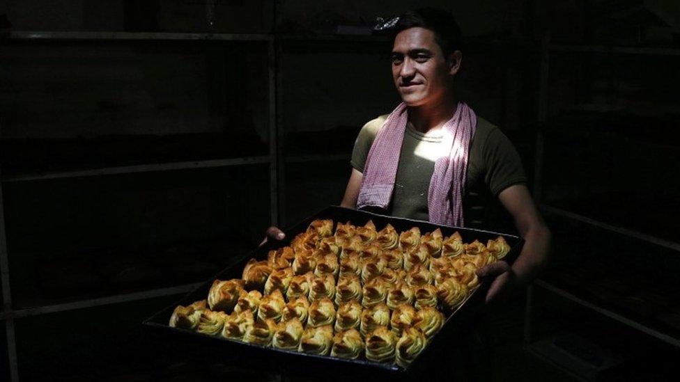 An Afghan man prepares for Eid