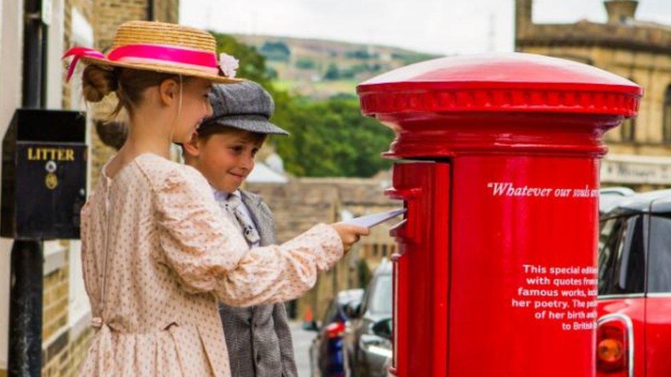 Children from Thornton Primary post letters in the Emily Bronte commemorative postbox