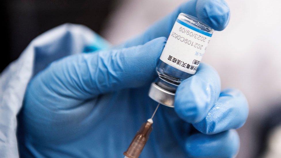 A medical worker prepares a dose of the Sinopharm Covid-19 coronavirus vaccine