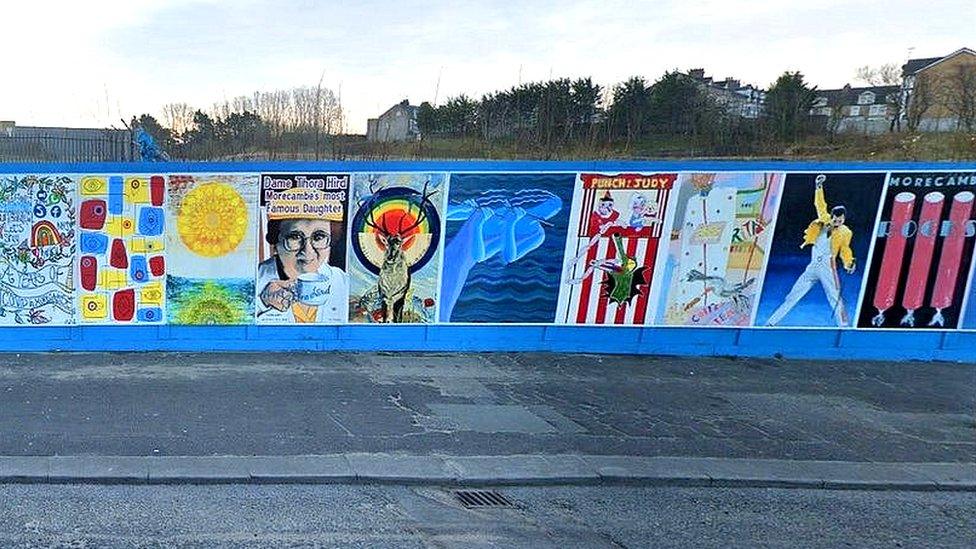 Murals on blue fence on Morecambe seafront